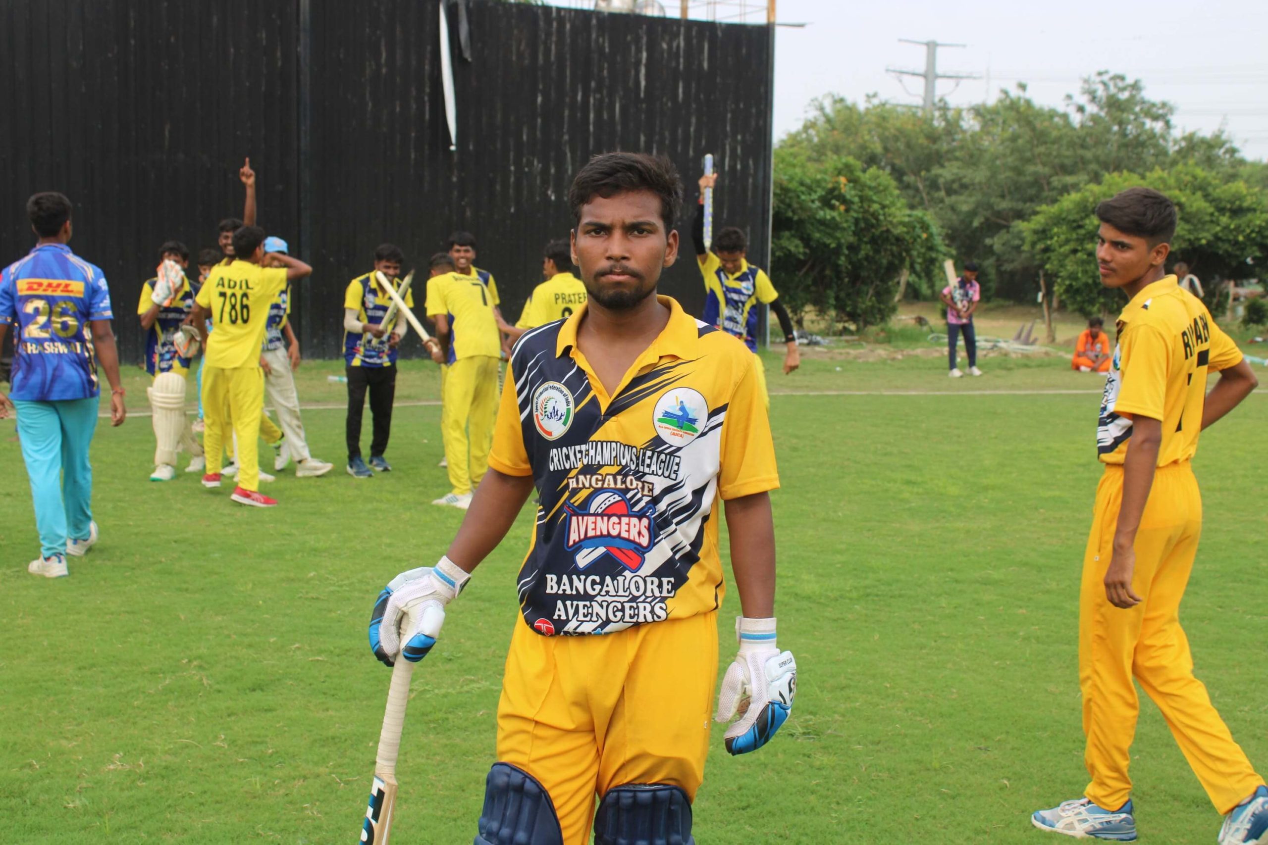 T20 ICL 2025 cricket player posing with bat on the ground
