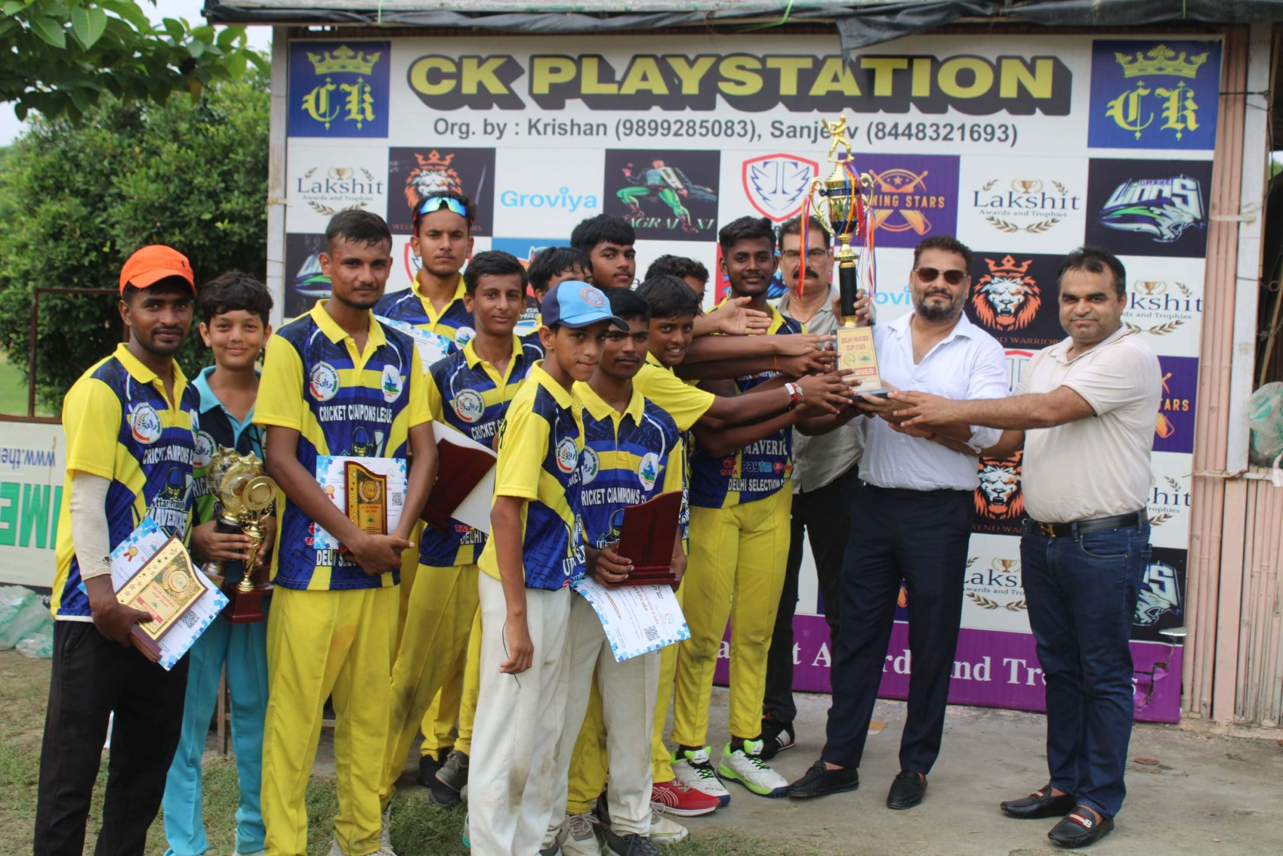 cricket players showing their certificates proudly