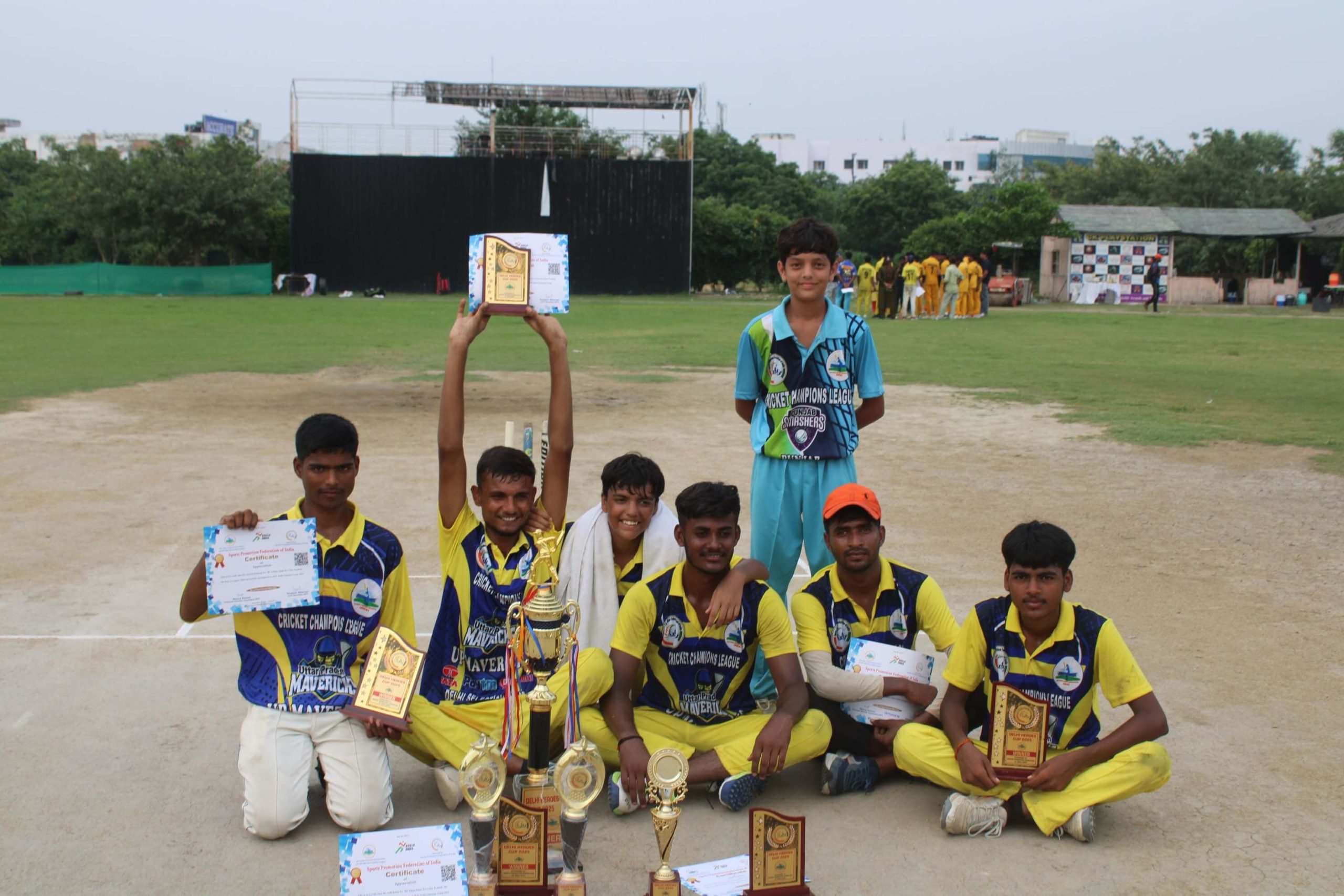 cricket players showing their certificates proudly