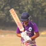 Cricketer timing a straight drive that races to the fence