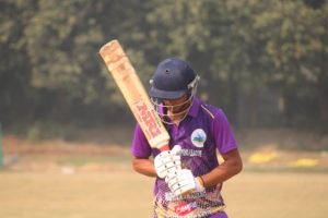 Cricketer timing a straight drive that races to the fence