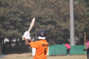 Batsman hitting a four in cricket match action