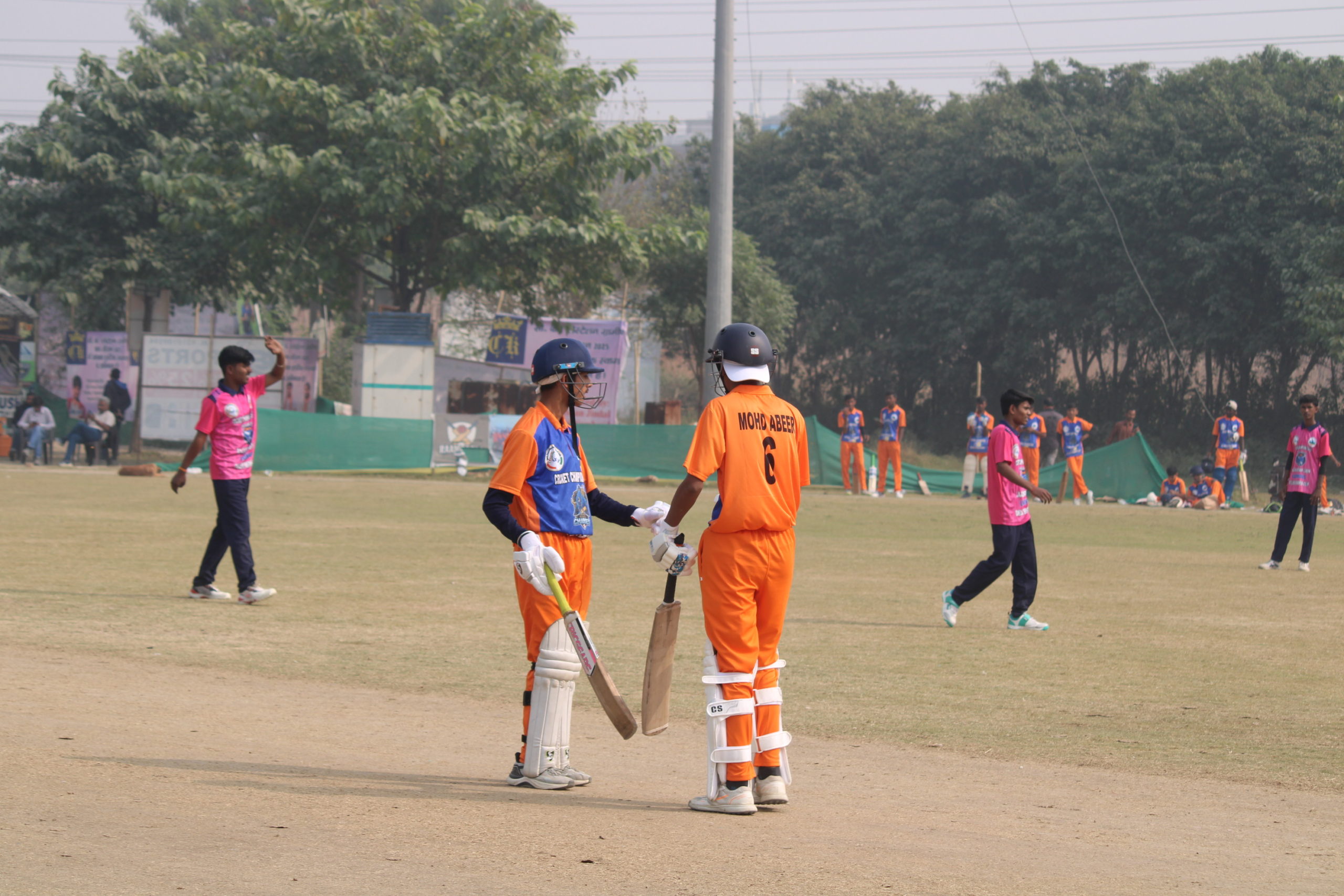 Batsman discussing batting strategy with coach during practice