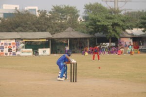Batsman hitting a powerful shot over the boundary in a cricket match