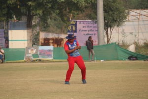 Cricketer taking a high catch during fielding drill